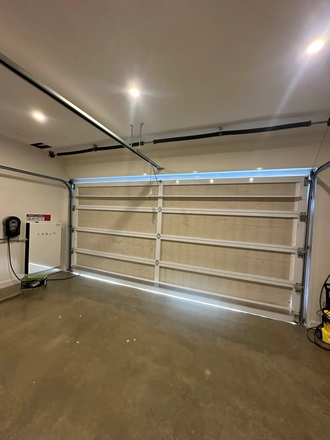 Interior view of a modern sectional garage door in a luxury home garage on Cronin Island