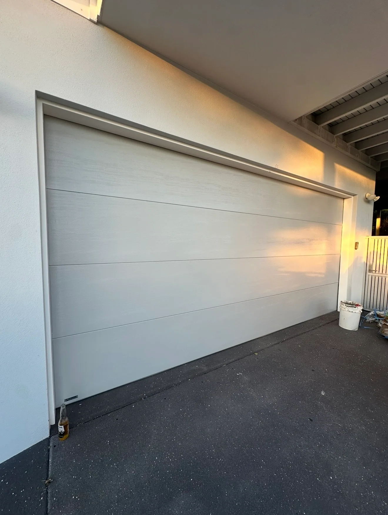 Technician servicing a garage door on an acreage property in the Bilambil hinterland