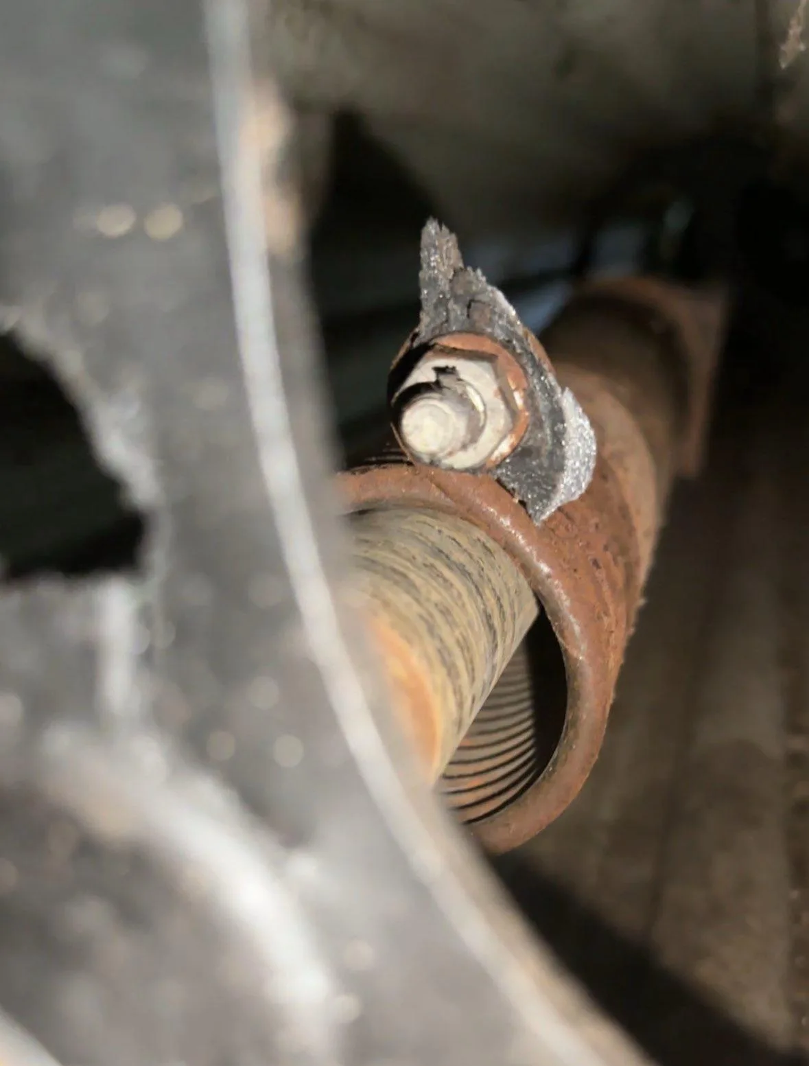 Rusty garage door spring showing corrosion from Gold Coast salt air